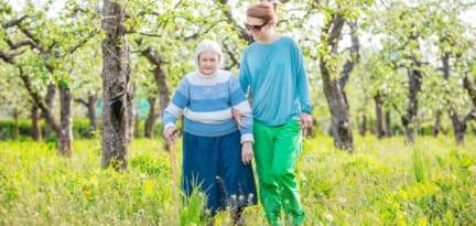 senior woman supported by granddaughter walking P7GKT9L 1